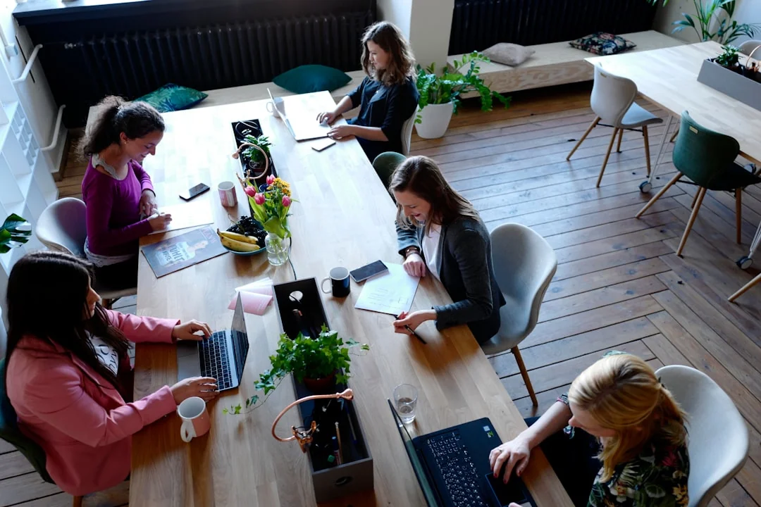 Two colleagues work together on a marketing strategy at a whiteboard, with a focus on user-generated content.